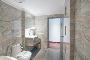 a bathroom with a toilet and a sink at A&EM - The Petit Hotel in Ho Chi Minh City +28 photos