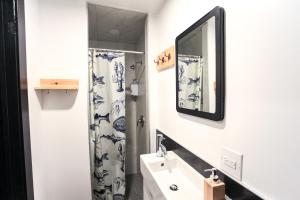 a bathroom with a sink and a mirror at Auberge Saintlo Montréal Hostel in Montreal