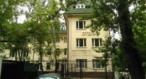 a building with a fence in front of it at Minima Kuzminki in Moscow