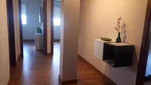a hallway with a room with a tv on a wall at Barrañán Arena in Arteixo +36 photos