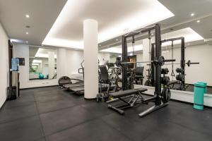 a gym with treadmills and elliptical machines at River Chateau Hotel in Rome