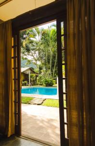 a view of a pool through a window at Condomínio Boiçucanga in Boicucanga