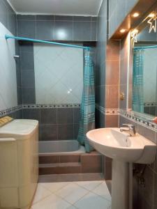 a bathroom with a sink and a toilet and a tub at Your Dream Apartment in Agouza "FAMILY ONLY" in Cairo