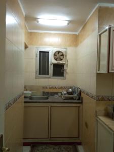 a small kitchen with a sink and a microwave at Your Dream Apartment in Agouza "FAMILY ONLY" in Cairo