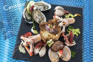 a plate of food with seafood and vegetables on it at Hotel Ristorante Centosedici in Terracina