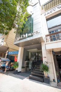 a store front of a building with stairs in front at A&EM - The Petit Hotel in Ho Chi Minh City