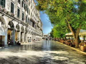 a city street with people walking down the street at Alsos Family Apartment in Corfu +10 photos