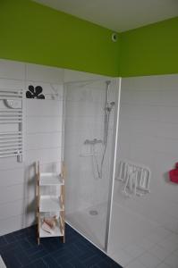 a shower with a glass door in a bathroom at Chez Tib in Trégunc