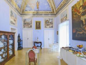 Cette grande chambre dispose d'un plafond orné de peintures sur les murs. dans l'établissement Pascaraymondo Suite Palace, à Gallipoli