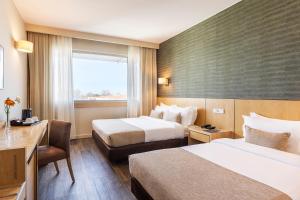 波多的住宿－HF伊帕內瑪波爾圖，酒店客房设有两张床和窗户。