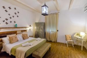 a bedroom with a bed and a desk in it at Domatia in Barletta