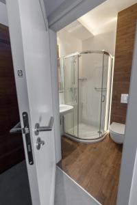 a bathroom with a glass shower and a toilet at Novopolska - Hotel i Restauracja in Kościan