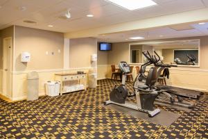 a gym with treadmills and exercise equipment in a room at Blue Water Resort in South Yarmouth