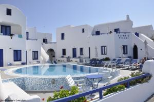 a swimming pool in front of a building at Olympic Villas in Oia