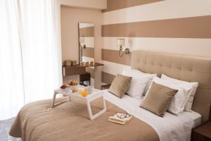 a bedroom with a bed with a table on it at AT.thea ATHENS BOUTIQUE APARTMENTS in Athens