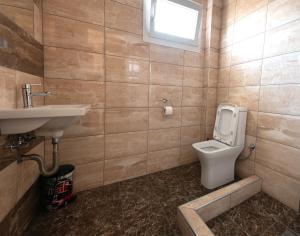 a bathroom with a toilet and a sink at Olympic Coast in Olympic Beach