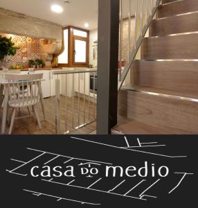 a kitchen and a staircase with a casa do medico sign on it at Casa Do Medio in Santiago de Compostela