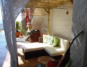a living room with a couch on a patio at Corte Risco in Ogliastro Cilento