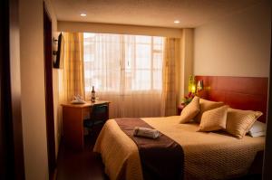 Säng eller sängar i ett rum på Hotel San Ignacio Plaza