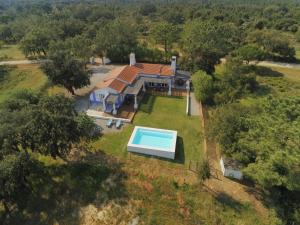 an aerial view of a house with a swimming pool at Herdade do Frei Cuco in Santiago do Cacém