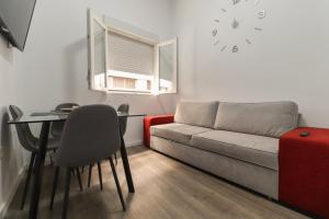 a living room with a couch and a table at Apartamentos Bello Tenerife in Santa Cruz de Tenerife