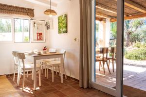 una cucina e una sala da pranzo con tavolo e sedie di Casa Little China a Es Pujols