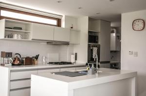 a kitchen with white cabinets and a counter top at Aizarker in La Plata
