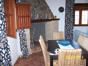 a dining room with a table and chairs and a fireplace at Casa Rural Altozano Elche de la Sierra in Elche de la Sierra