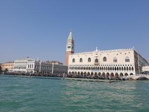 a view of a building on the water next to a bridge at Casa Mafalda in Chioggia