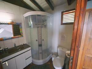 a bathroom with a shower and a toilet and a sink at karureve in Deshaies