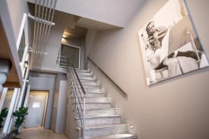 a staircase in a house with a picture on the wall at City Lofts in Alexandroupoli