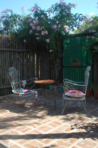 a patio with two chairs and a table and a table at Blue House in Concordia