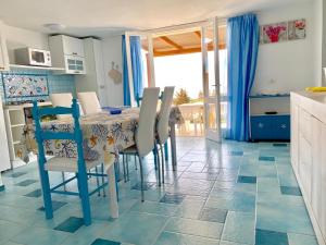a kitchen with a table and chairs in a kitchen at Casa Vacanze Miranda in Torre Dei Corsari +32 photos