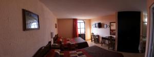 a living room with a table and a dining room at Hotel San Angel in Puebla +31 photos