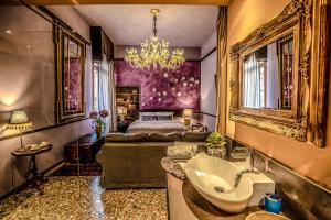 a bathroom with a sink and a bed in a room at Avogaria 5 Rooms in Venice