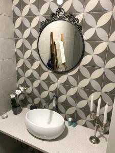 a bathroom with a sink and a mirror at Mouraria House - Casa de Charme - Centro Histórico in Évora