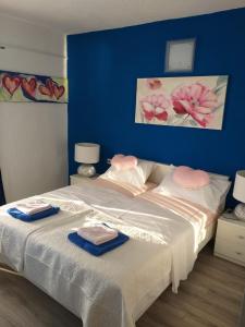 a bedroom with a bed with two towels on it at Rooms Bero in Senj