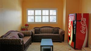 a living room with a coke machine and a couch at Antonio Hotel - Downtown Los Angeles, near Hollywood in Los Angeles