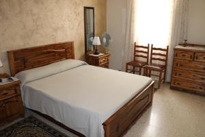a bedroom with a large bed and two chairs at Sea front apartment in Marsaskala