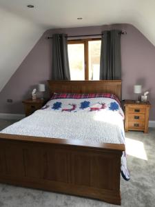 a bedroom with a bed and a window at Tigh a Chabar in Lochaline