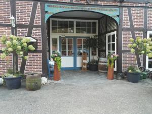 an entrance to a brick building with potted plants at Pröve Hof in Eicklingen