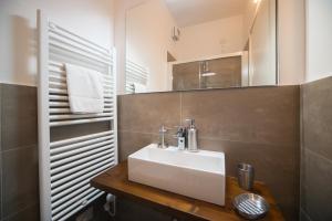 a bathroom with a white sink and a mirror at Casa Stazione in Verona