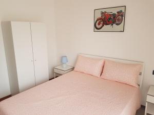 a bedroom with a bed and a motorcycle on the wall at Foresteria Giulia in Bergamo