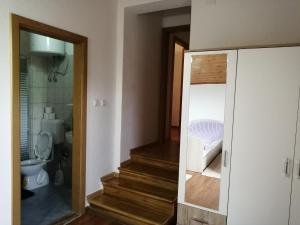 a bathroom with a stairway leading to a room with a bed at Amina River Apartment in Bihać +73 photos
