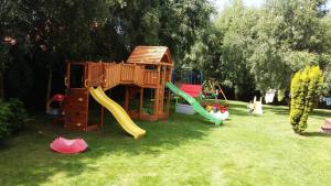 a playground with a slide and a play house at Willa Nauta in Dębki