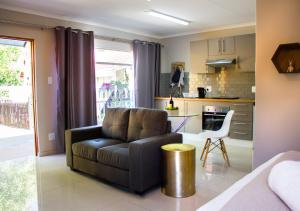 a living room with a couch and a kitchen at Fuhri Road Apartments Madison House in Alberton