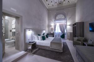 a hotel room with a large bed and a large window at Terrace Pantheon Relais in Rome