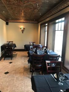 a dining room with black tables and chairs at Riverside Hot Springs Inn & Spa - Adults Only in Lava Hot Springs