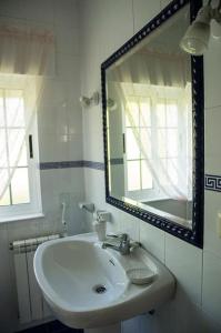 a bathroom with a sink and a large mirror at Apartamento Amieiro in Ribadeo
