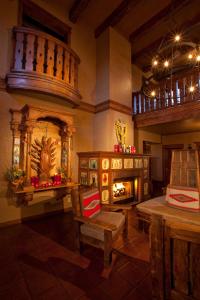 
a living room filled with furniture and a fire place at Hotel Chimayo de Santa Fe in Santa Fe
